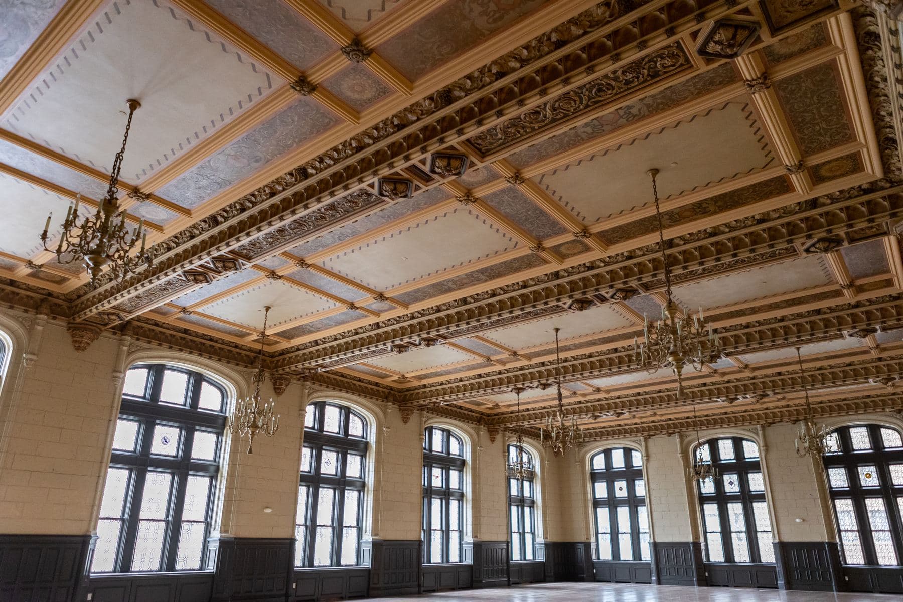 The coffered ceiling and lead glass windows of the ballroom