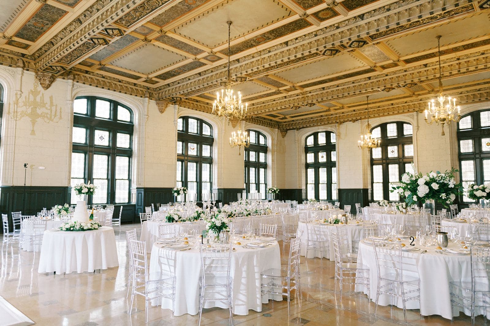 The ballroom set with round tables and florals